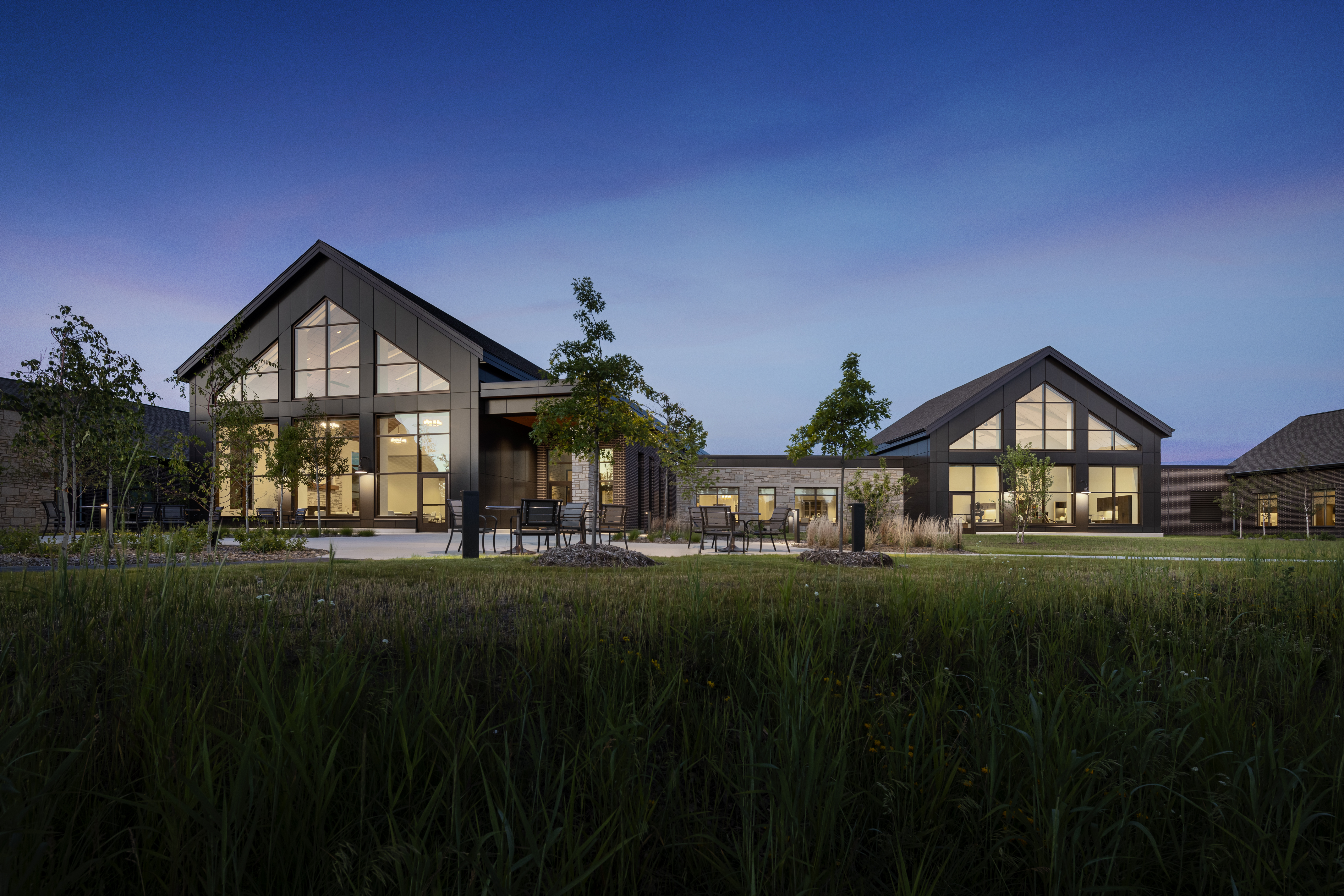 MDVA Bemidji Photo Ext Town Center Plaza Dusk Photograph by Andrew Rugge Copyright Perkins Eastman